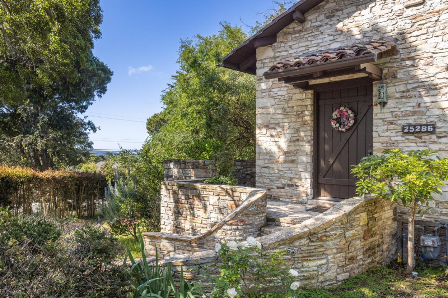 25286 Hatton Road Carmel, CA 93923 - Photo 2 of 34 a front view of a house with garden