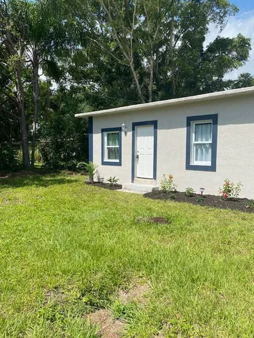 a front view of house with yard and trees