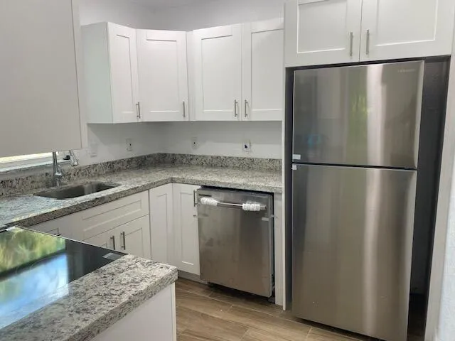 a kitchen with a refrigerator and a sink