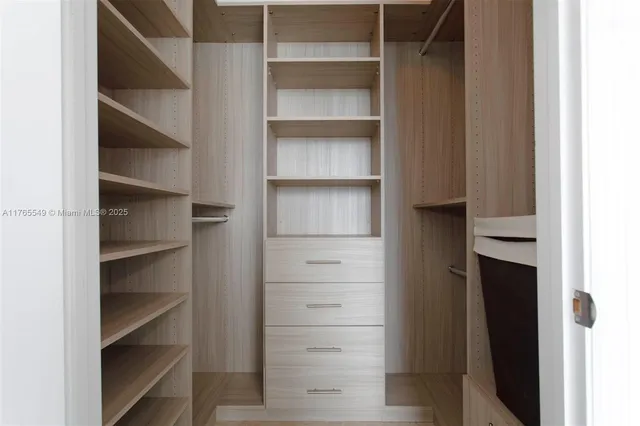 a bathroom with a granite countertop sink a mirror and a bathtub