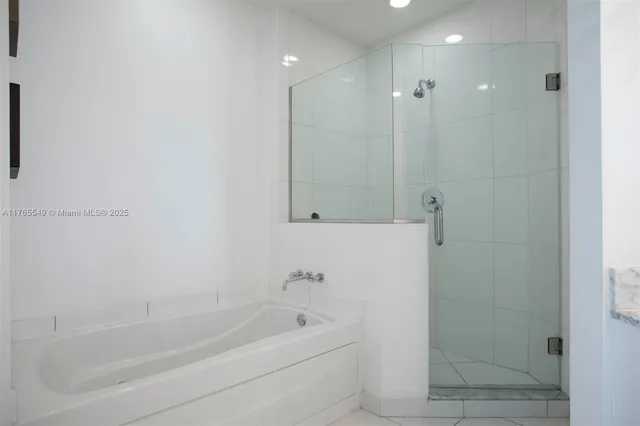 a bedroom with a bed a table and painting