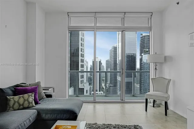 a living room with furniture and a glass door