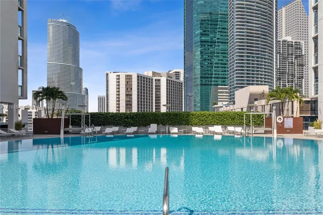 a swimming pool with outdoor view and tall buildings