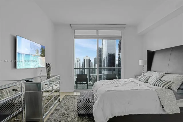 a bedroom with a bed and a large window