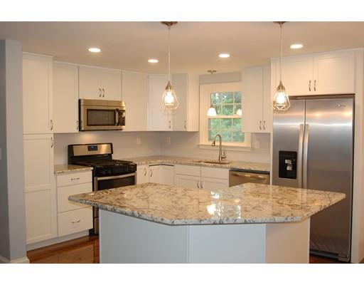 5 Westgate Road Framingham, MA 01701 - Photo 2 of 14 a kitchen with kitchen island granite countertop a sink a counter top space appliances and cabinets