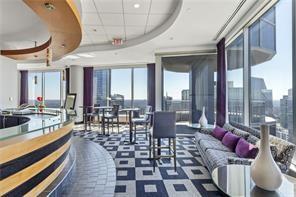 3338 Peachtree Road Northeast, Unit 1905 Atlanta, GA 30326 - Photo 13 of 19 a living room with furniture a rug and a chandelier