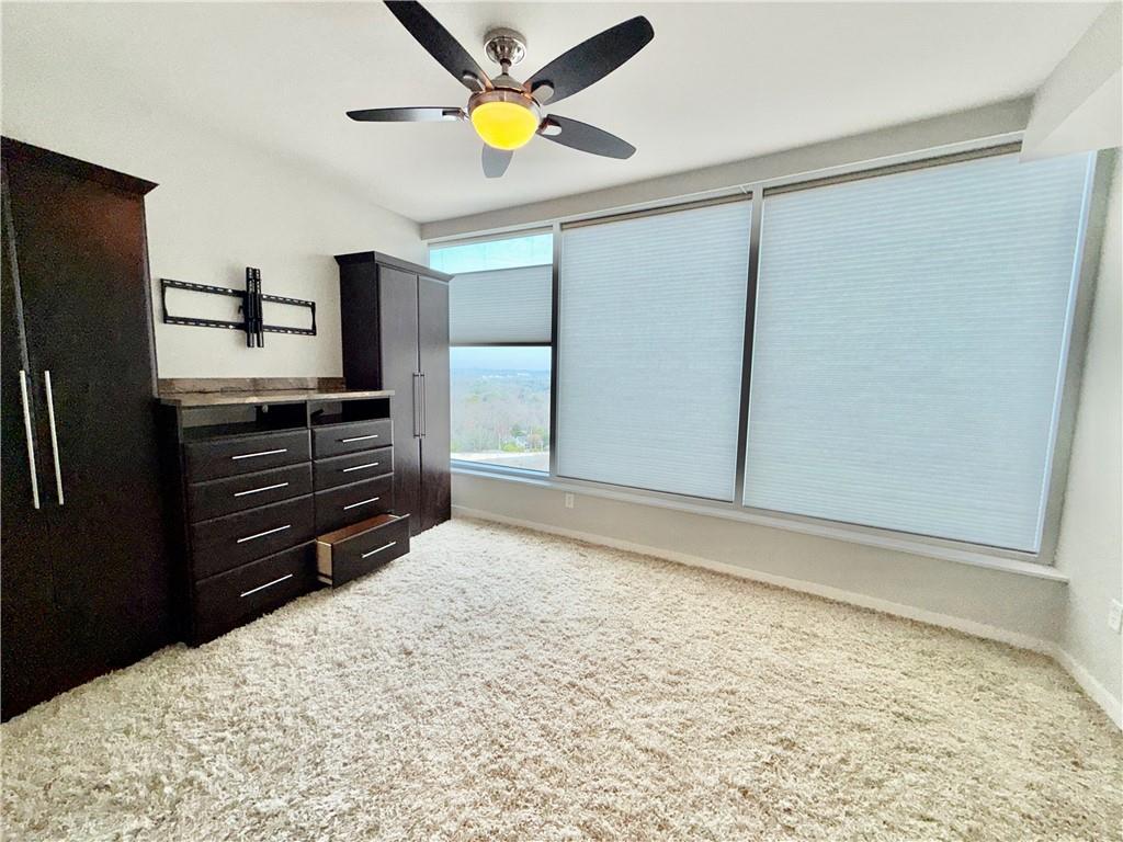 3338 Peachtree Road Northeast, Unit 1905 Atlanta, GA 30326 - Photo 6 of 25 a view of a kitchen with a sink and stainless steel appliances wooden floor