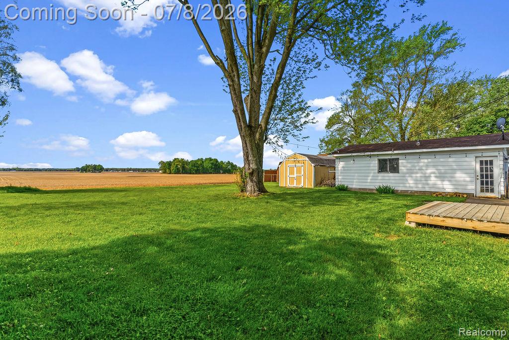 5698 McGrandy Road Bridgeport, MI 48722 - Photo 25 of 26 Expansive lawn featuring mature trees and a detached shed