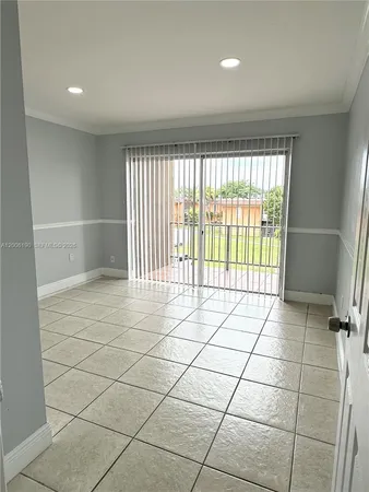 a view of an empty room and a window