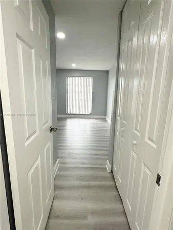 a view of an entryway with wooden floor