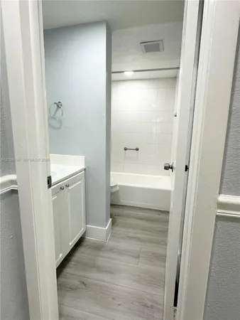 a bathroom with a tub and shower