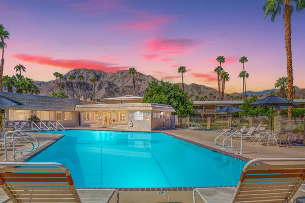 a view of a road with a house in the background