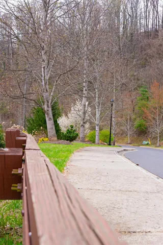 a view of a house with a big yard and large trees