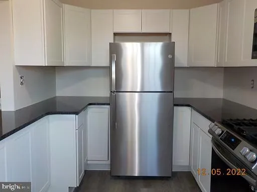 a white refrigerator freezer and a stove sitting inside of a kitchen