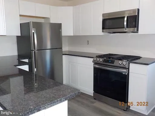 a kitchen with a stove and a microwave