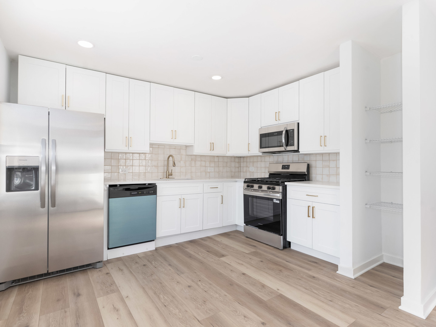 1917 Linden Avenue Hanover Park, IL 60133 - Photo 13 of 22 a kitchen with granite countertop a refrigerator stove and microwave