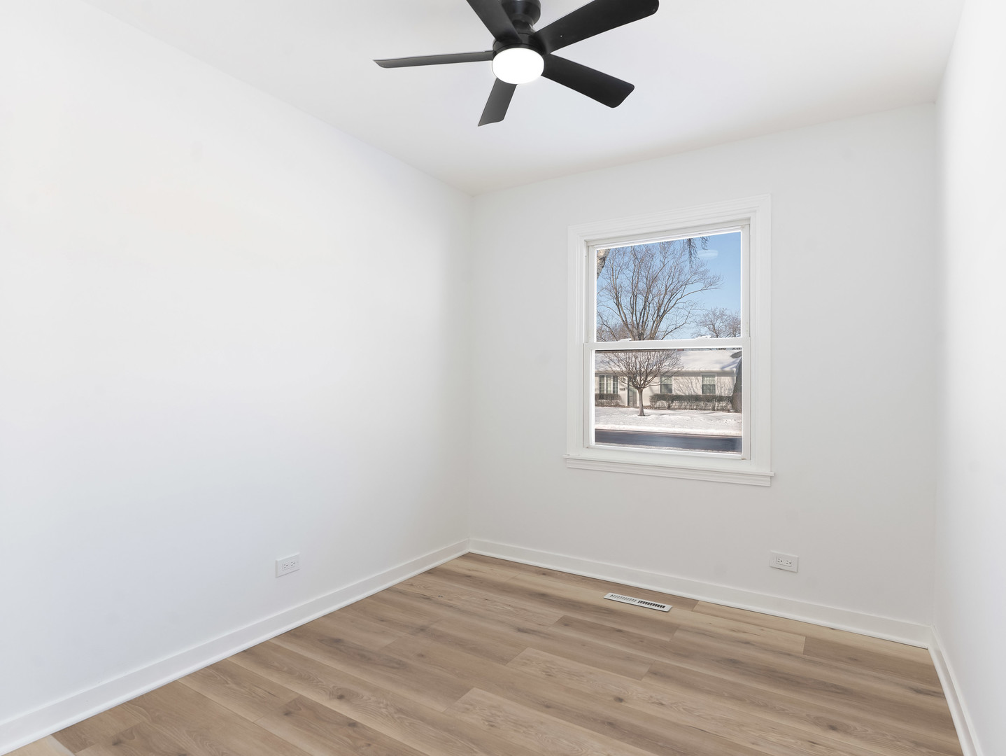 1917 Linden Avenue Hanover Park, IL 60133 - Photo 18 of 22 an empty room with wooden floor and windows