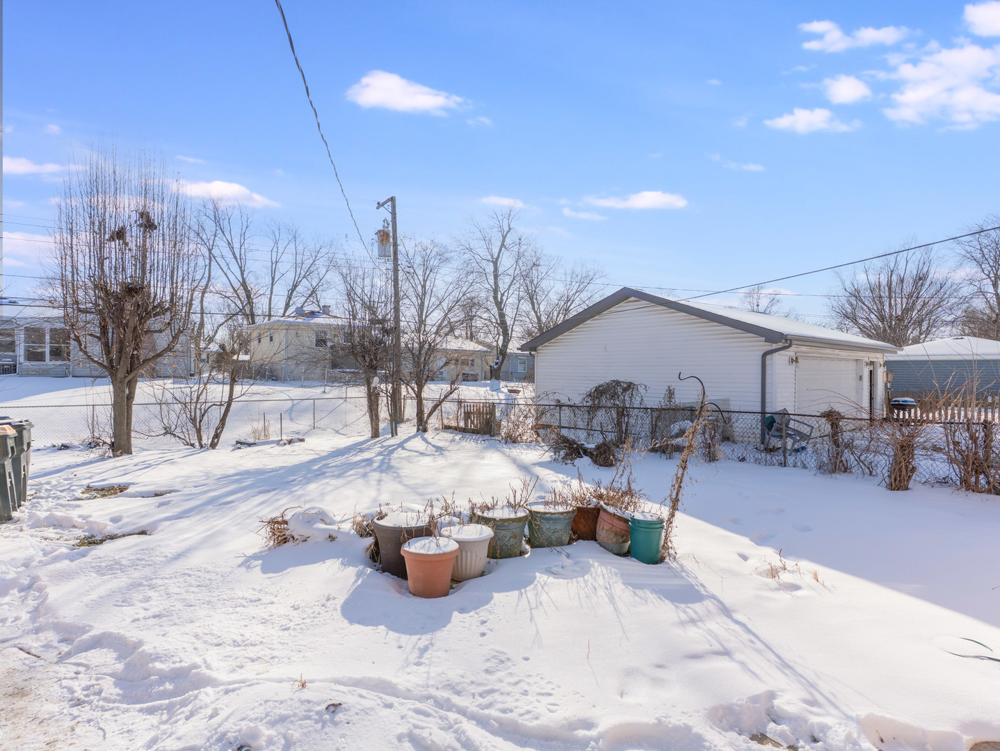 1917 Linden Avenue Hanover Park, IL 60133 - Photo 5 of 22 a view of a house with a yard covered in snow