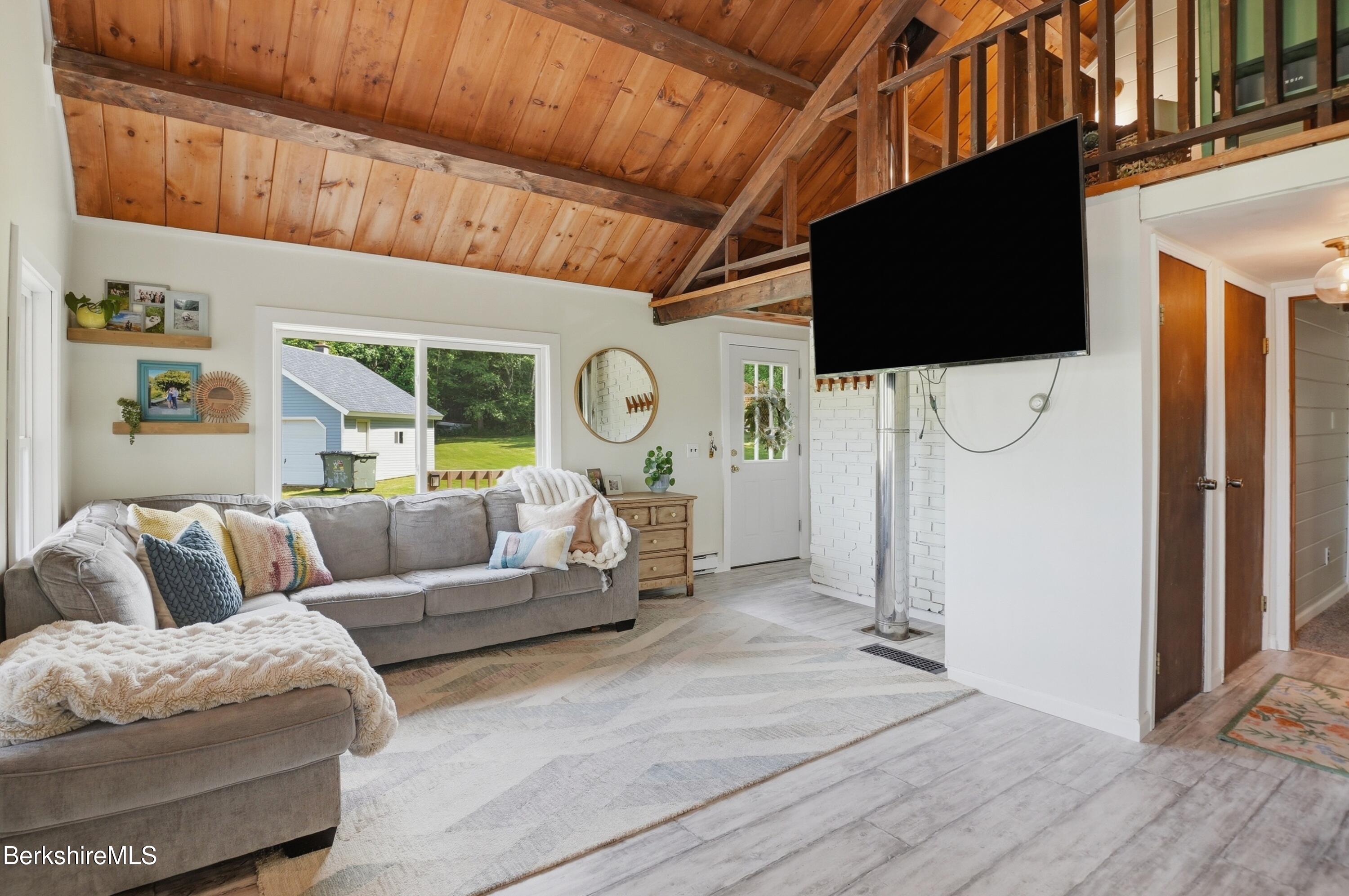 4 David Drive Peru, MA 01235 - Photo 8 of 44 a living room with furniture a flat screen tv and a floor to ceiling window