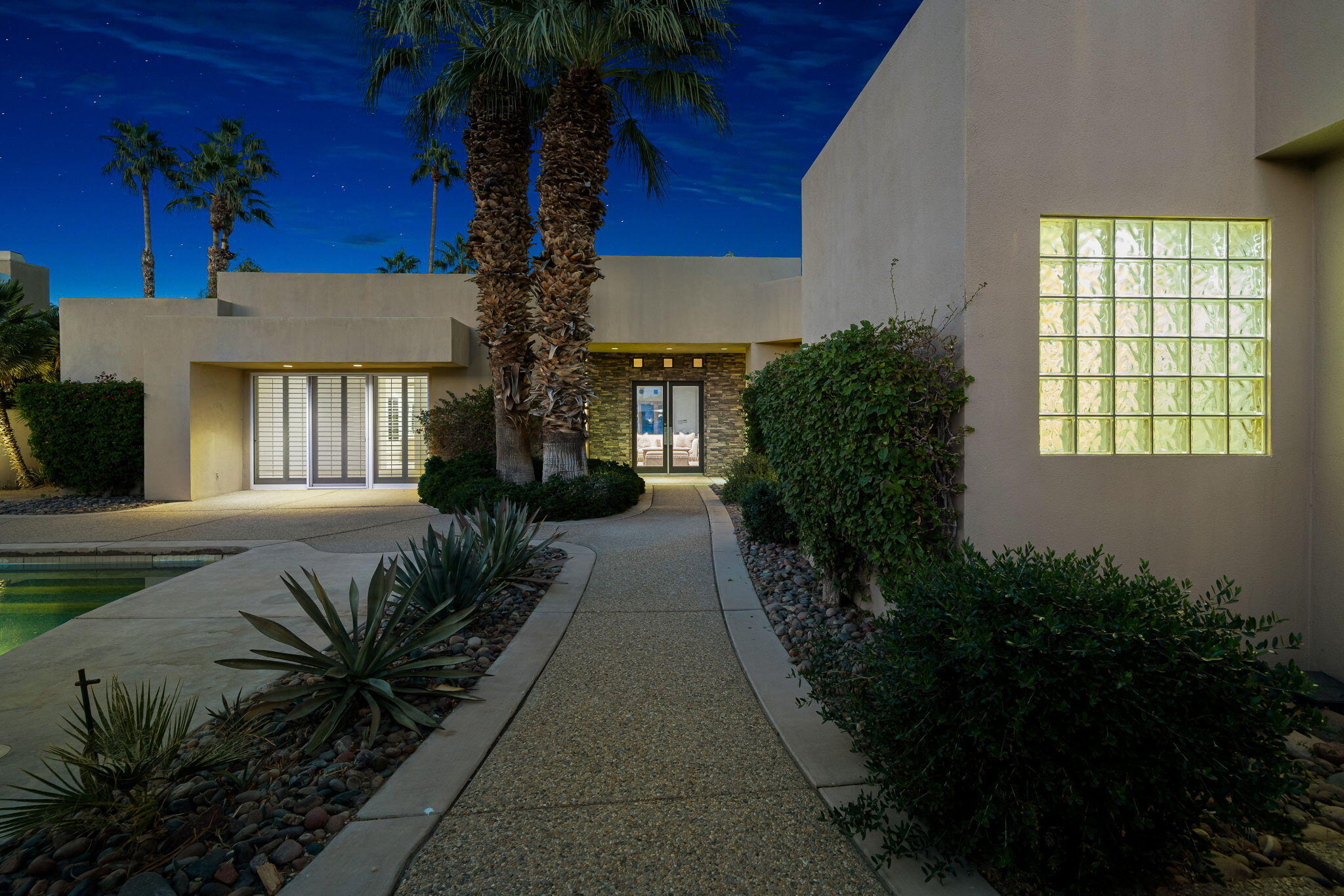 55770 Cherry Hills Drive La Quinta, CA 92253 - Photo 11 of 43 a house with potted plants in front of it