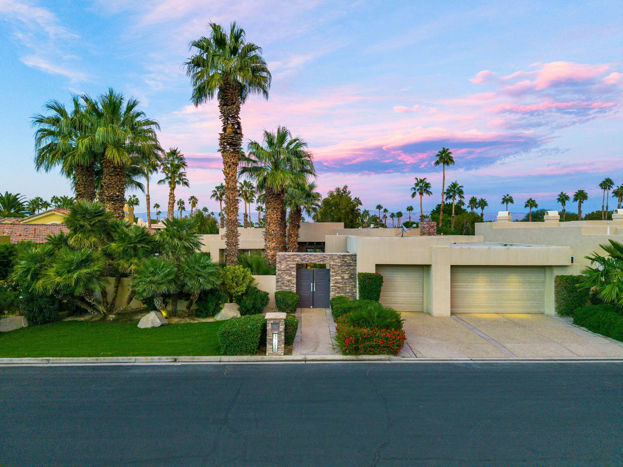 55770 Cherry Hills Drive La Quinta, CA 92253 - Photo 14 of 43 a front view of a house with a yard and trees