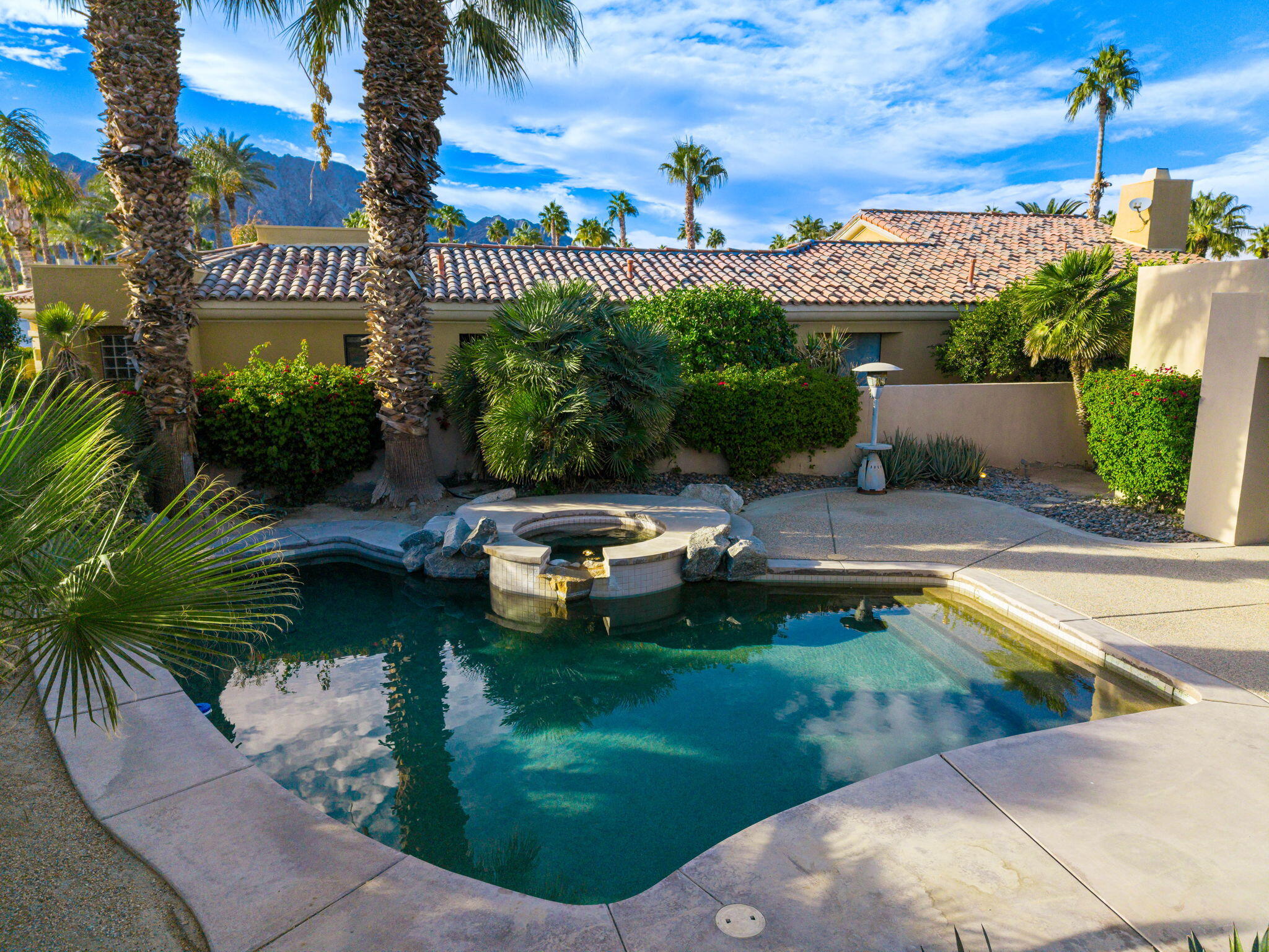 55770 Cherry Hills Drive La Quinta, CA 92253 - Photo 16 of 43 a swimming pool with outdoor seating and yard