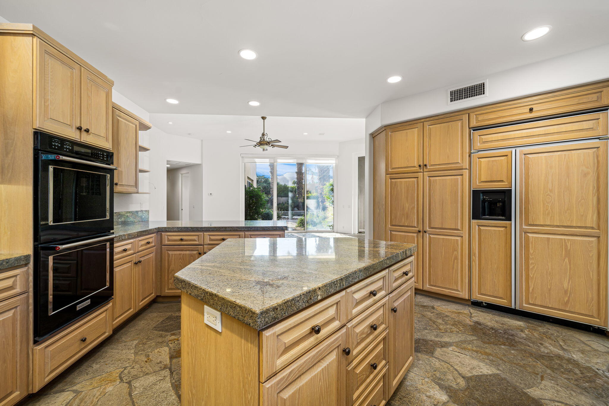 55770 Cherry Hills Drive La Quinta, CA 92253 - Photo 28 of 43 a kitchen with stainless steel appliances granite countertop a refrigerator a oven and a sink