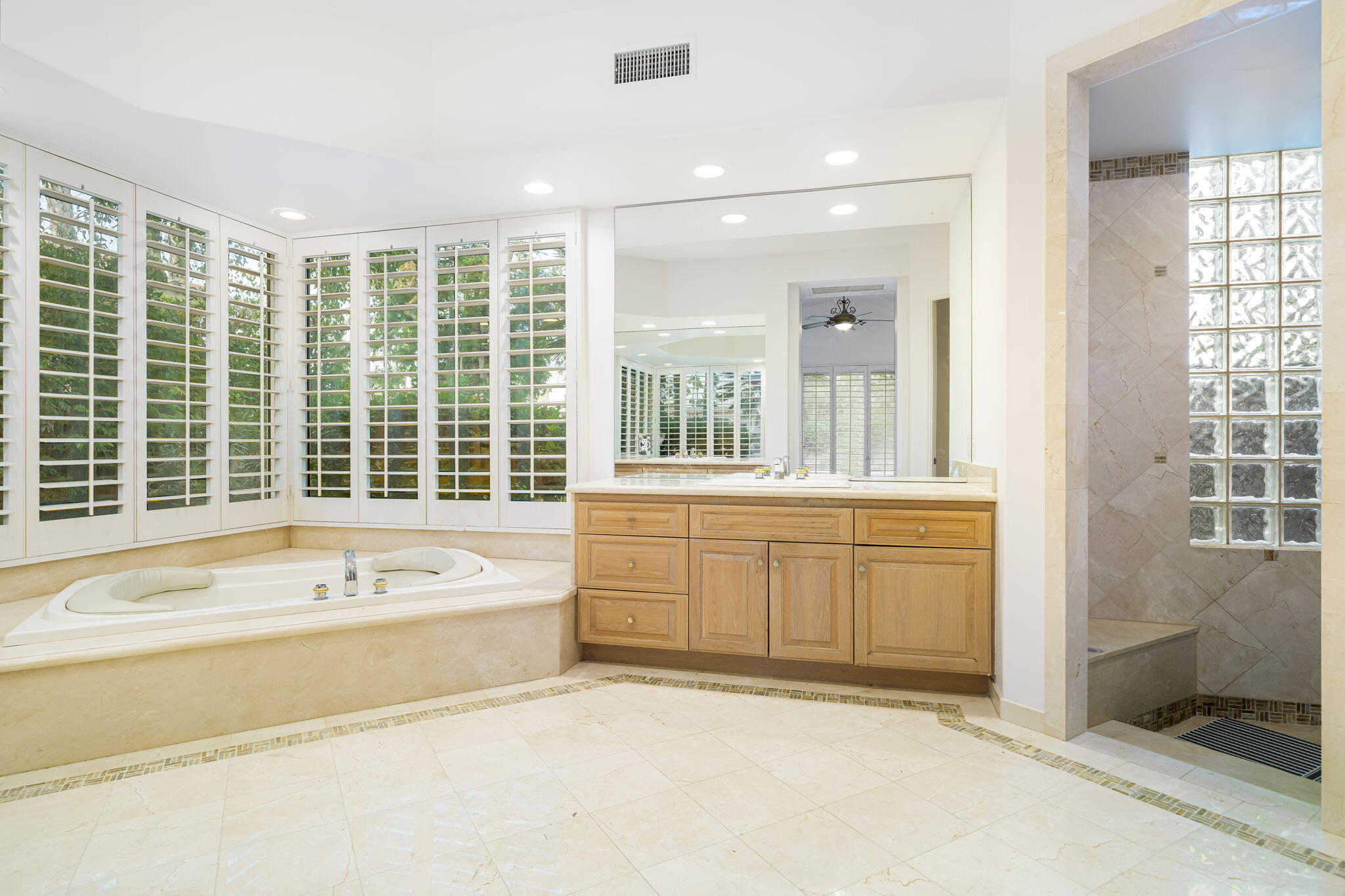 55770 Cherry Hills Drive La Quinta, CA 92253 - Photo 32 of 43 a spacious bathroom with a tub a sink and mirror