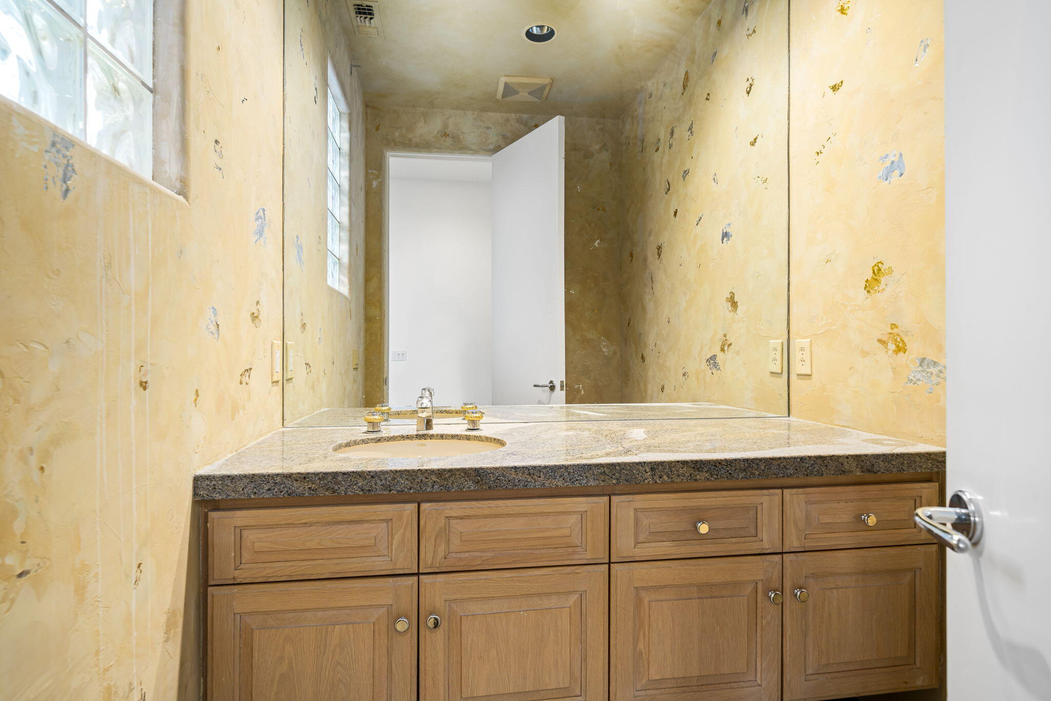 55770 Cherry Hills Drive La Quinta, CA 92253 - Photo 35 of 43 a bathroom with a granite countertop sink and a mirror