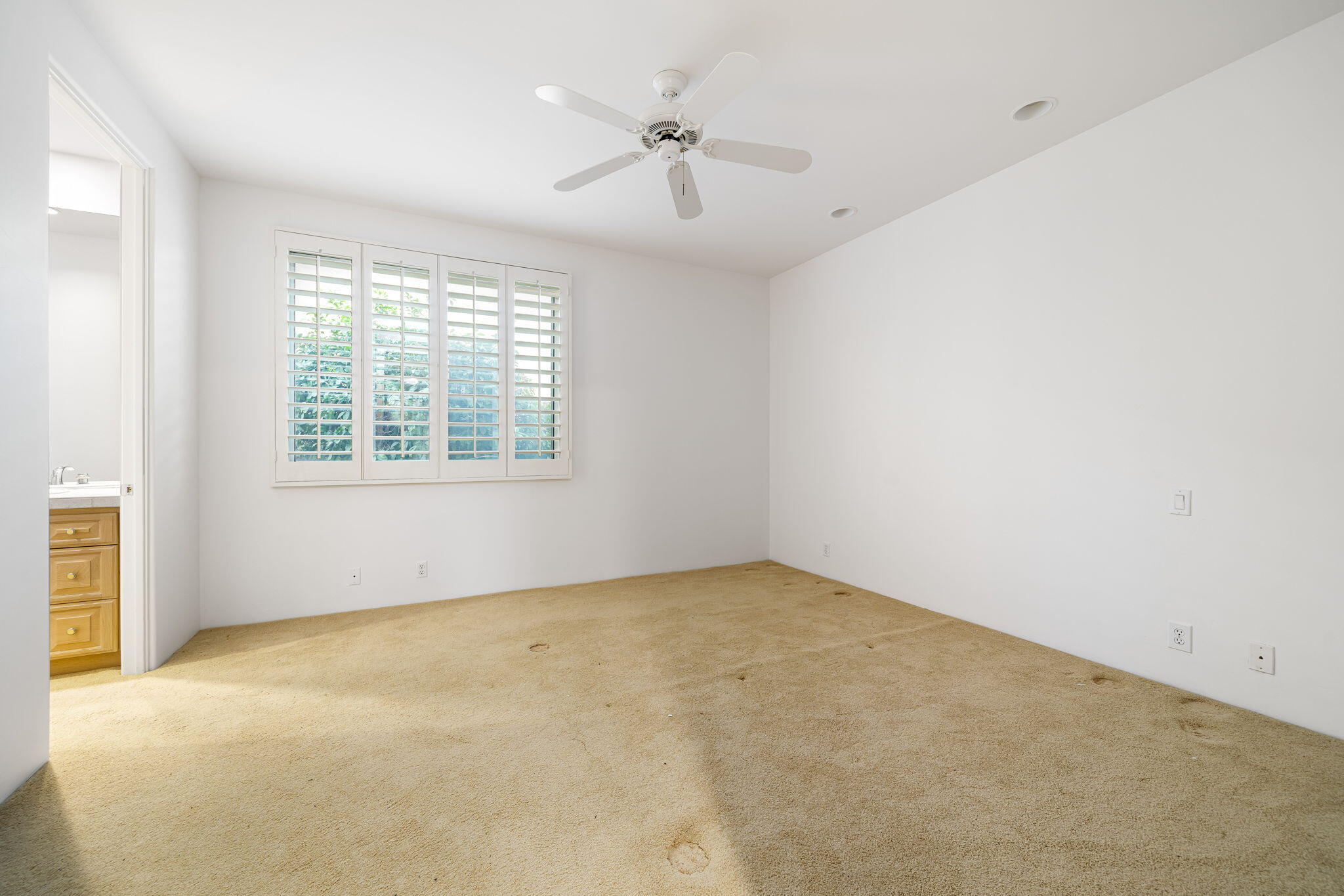 55770 Cherry Hills Drive La Quinta, CA 92253 - Photo 38 of 43 an empty room with a window and a ceiling fan