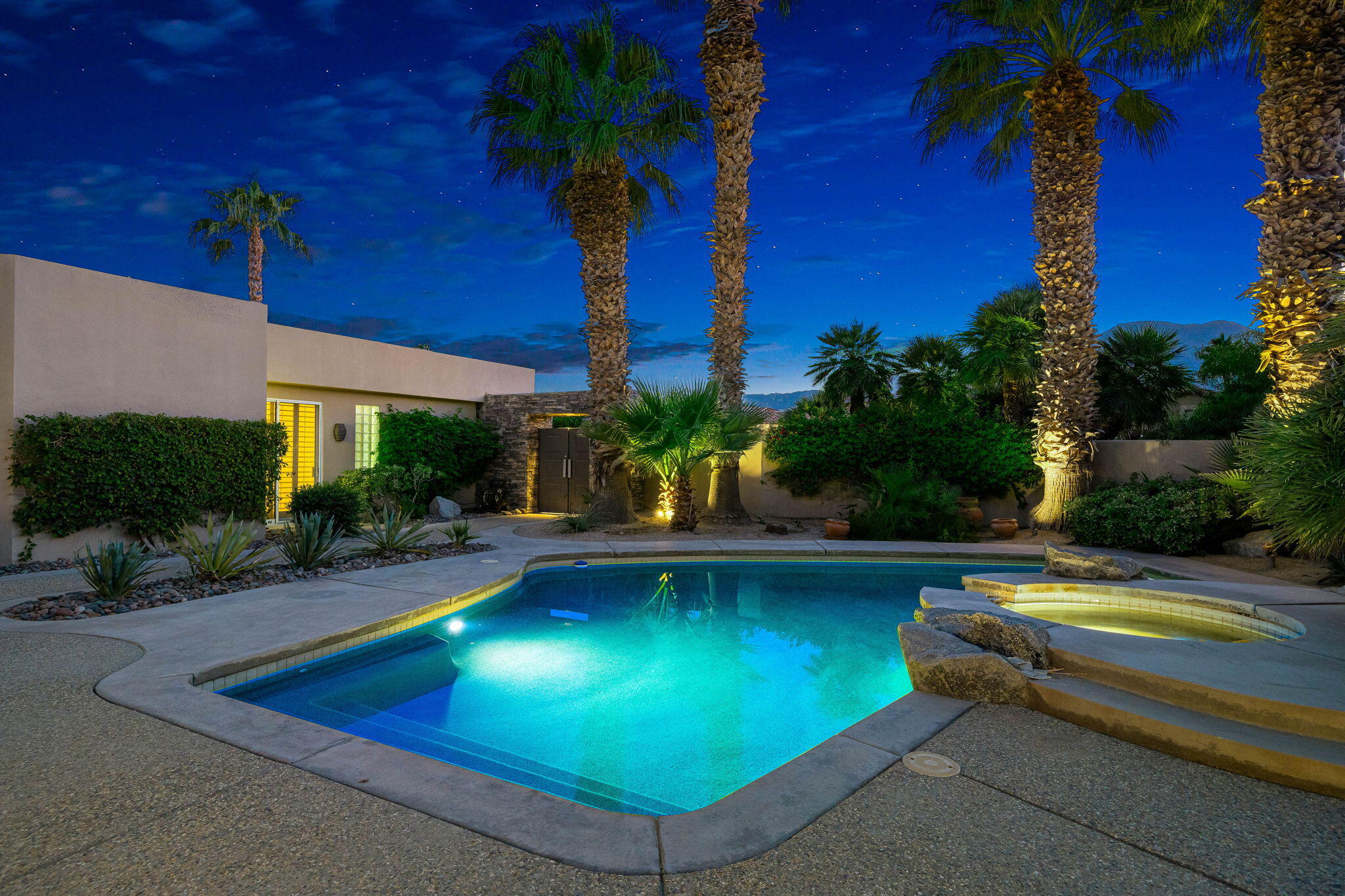 55770 Cherry Hills Drive La Quinta, CA 92253 - Photo 4 of 43 a view of a swimming pool with lawn chairs under an umbrella