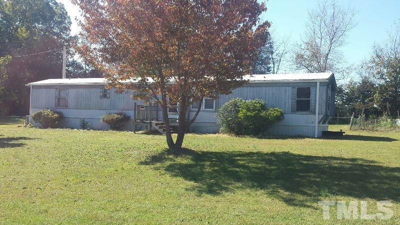 388 Saplin Branch Road Timberlake, NC 27583 - Photo 1 of 12 a backyard of a house with a yard and plants
