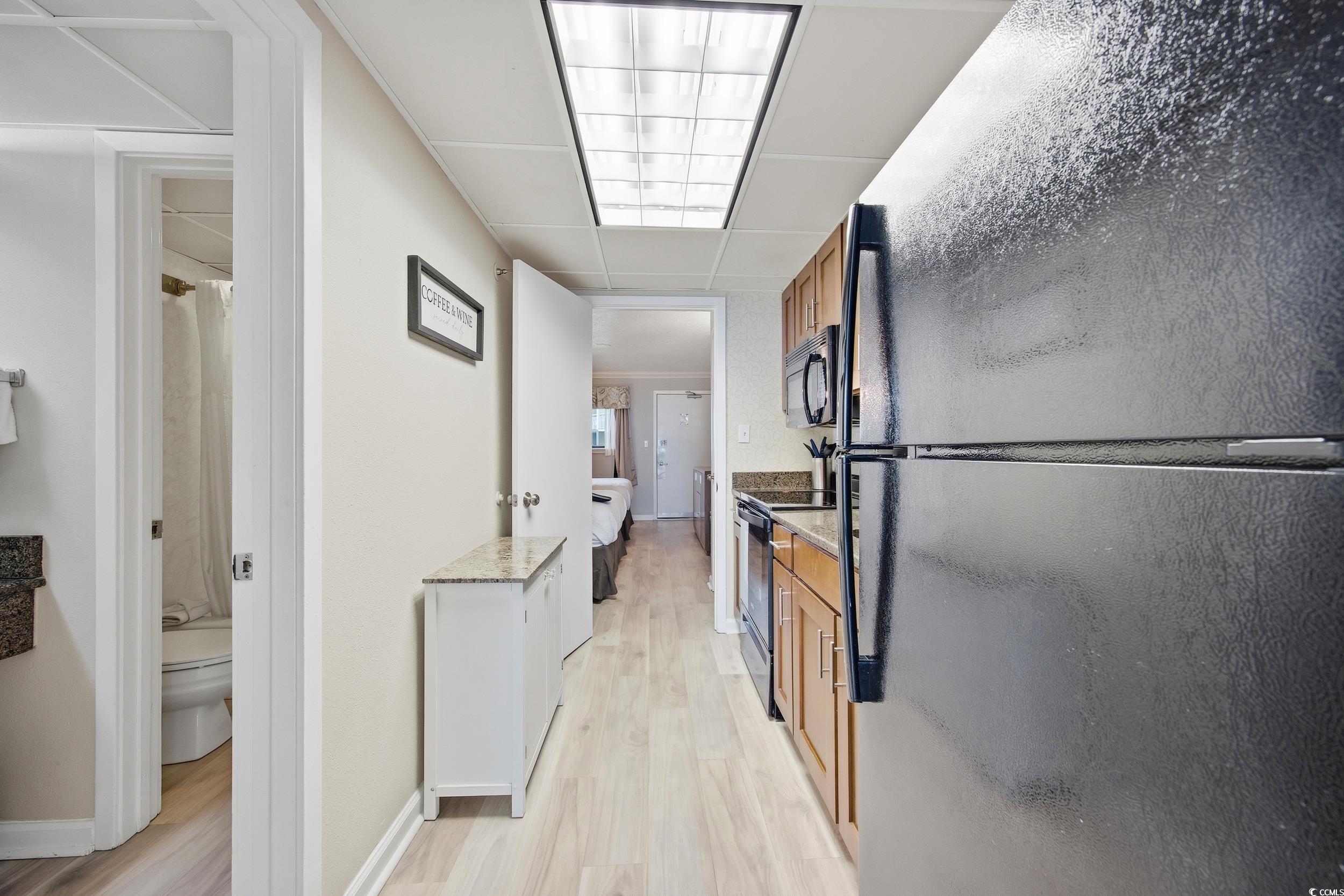 1105 South Ocean Boulevard, Unit 932 Myrtle Beach, SC 29577 - Photo 15 of 32 Hallway featuring light wood-style flooring