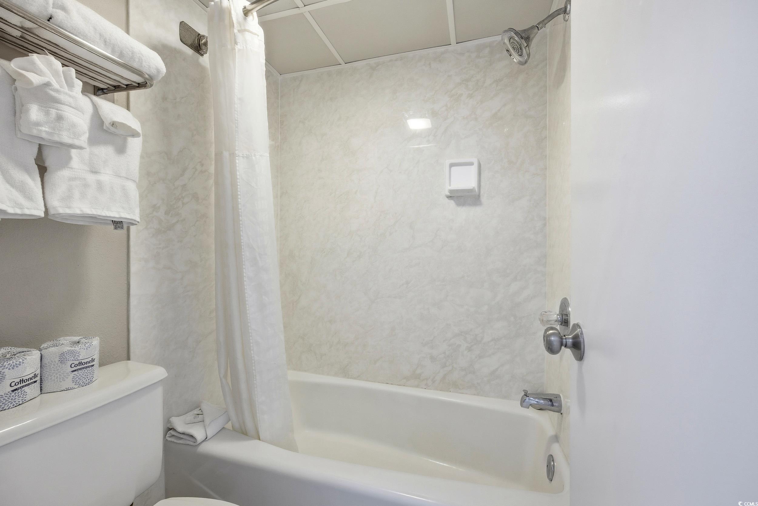 1105 South Ocean Boulevard, Unit 932 Myrtle Beach, SC 29577 - Photo 18 of 32 Full bathroom featuring shower / bathtub combination with curtain and toilet