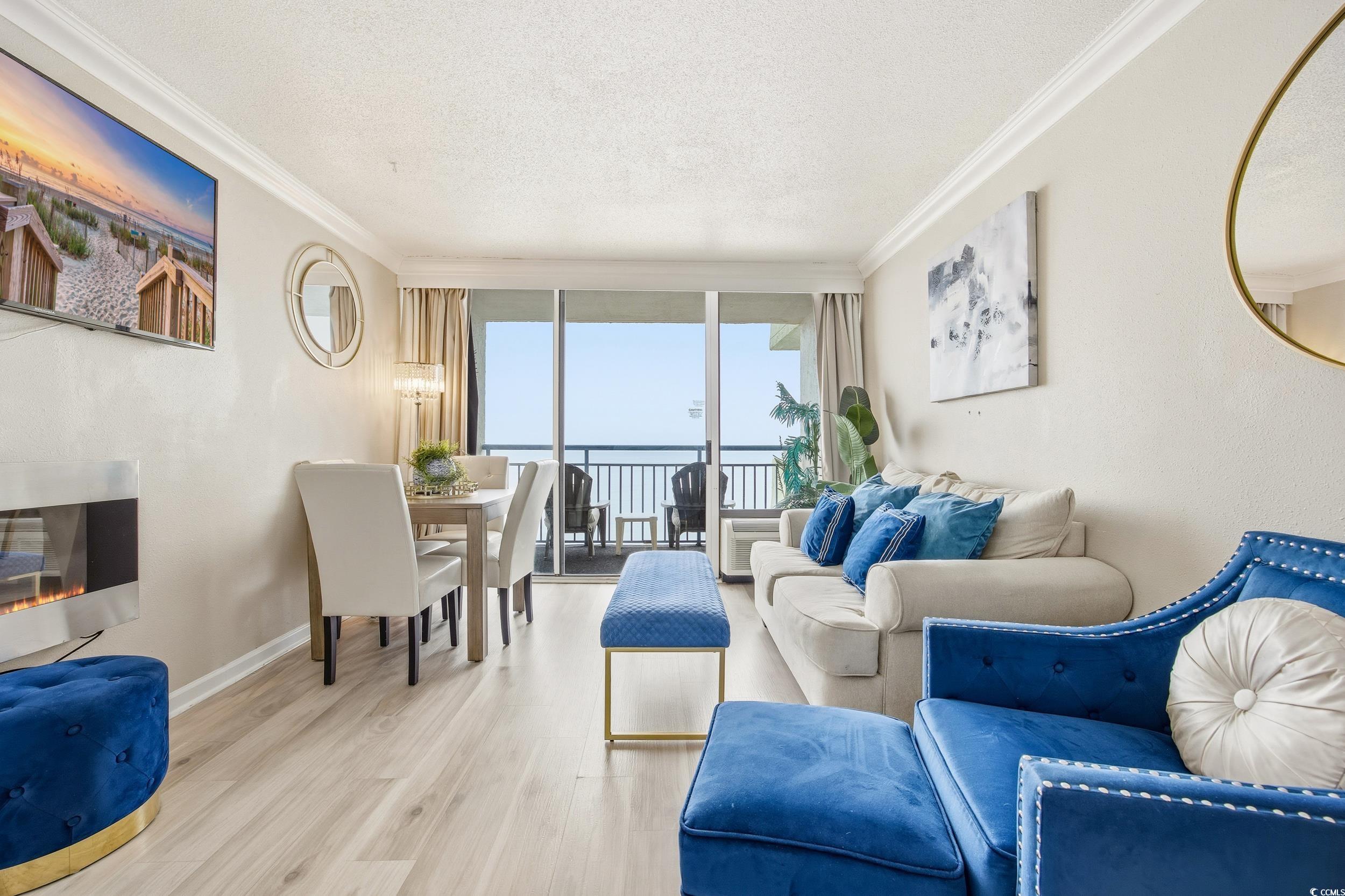 1105 South Ocean Boulevard, Unit 932 Myrtle Beach, SC 29577 - Photo 19 of 32 Living area featuring floor to ceiling windows, a textured ceiling, wood finished floors, and crown molding