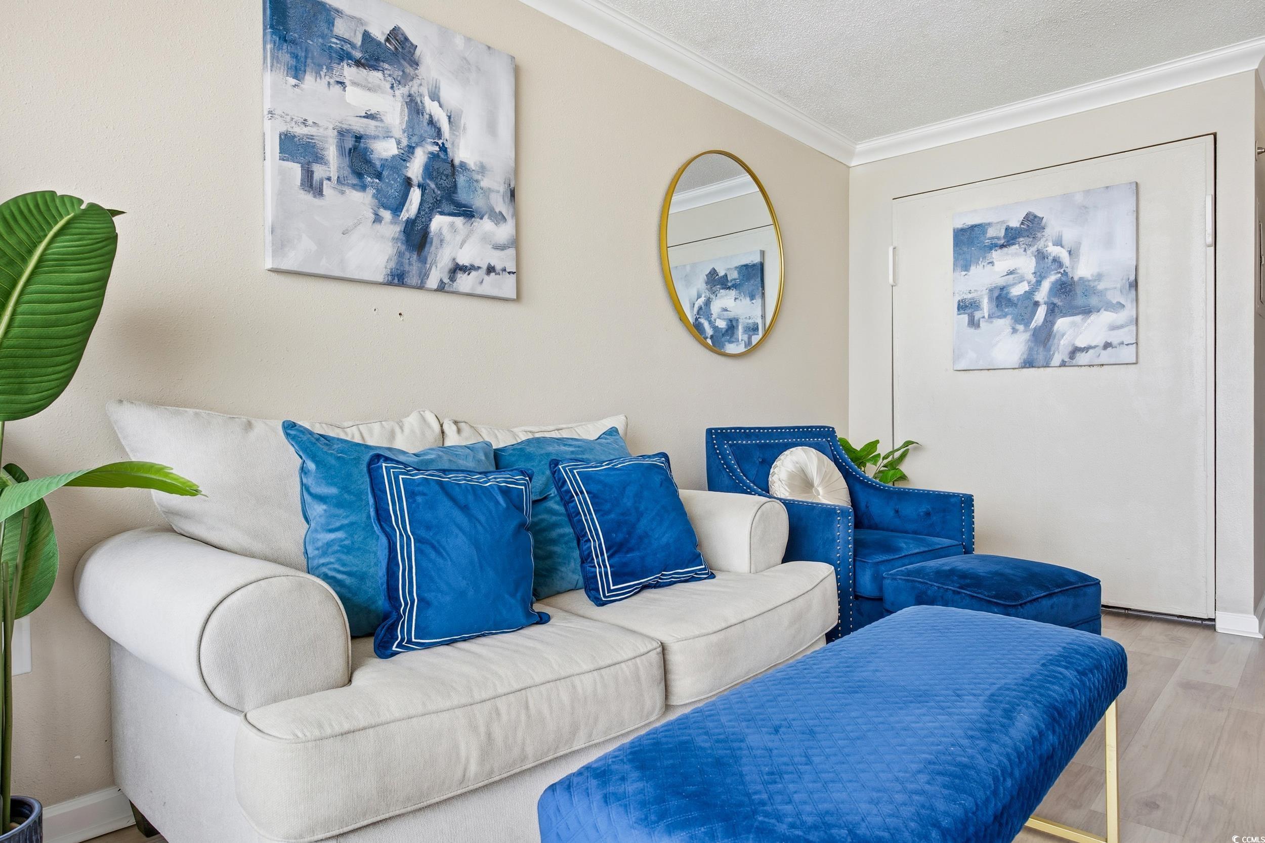 1105 South Ocean Boulevard, Unit 932 Myrtle Beach, SC 29577 - Photo 23 of 32 Living area featuring crown molding, wood finished floors, and a textured ceiling