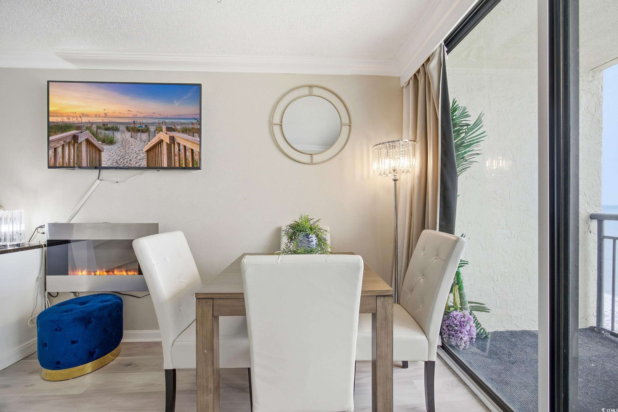 1105 South Ocean Boulevard, Unit 932 Myrtle Beach, SC 29577 - Photo 25 of 32 Dining room featuring wood finished floors and ornamental molding