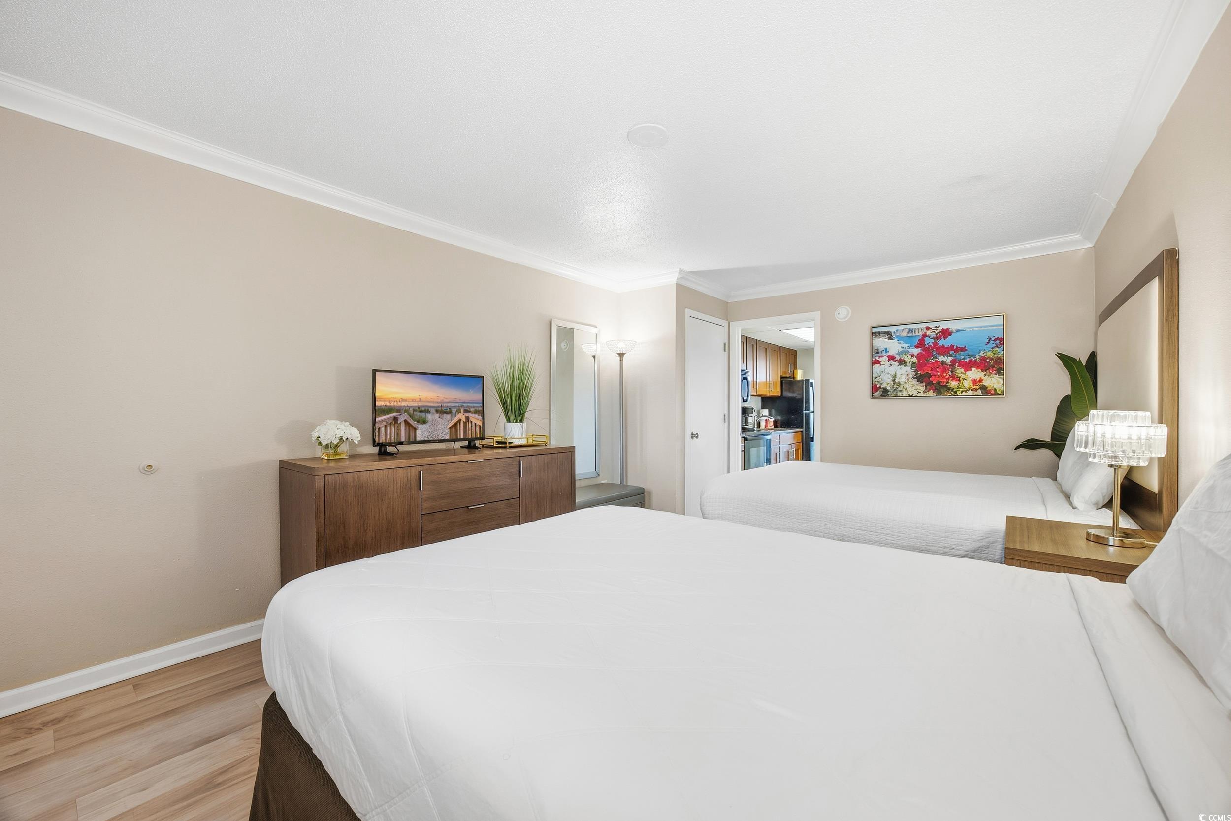 1105 South Ocean Boulevard, Unit 932 Myrtle Beach, SC 29577 - Photo 7 of 32 Bedroom with ornamental molding and light wood-style flooring