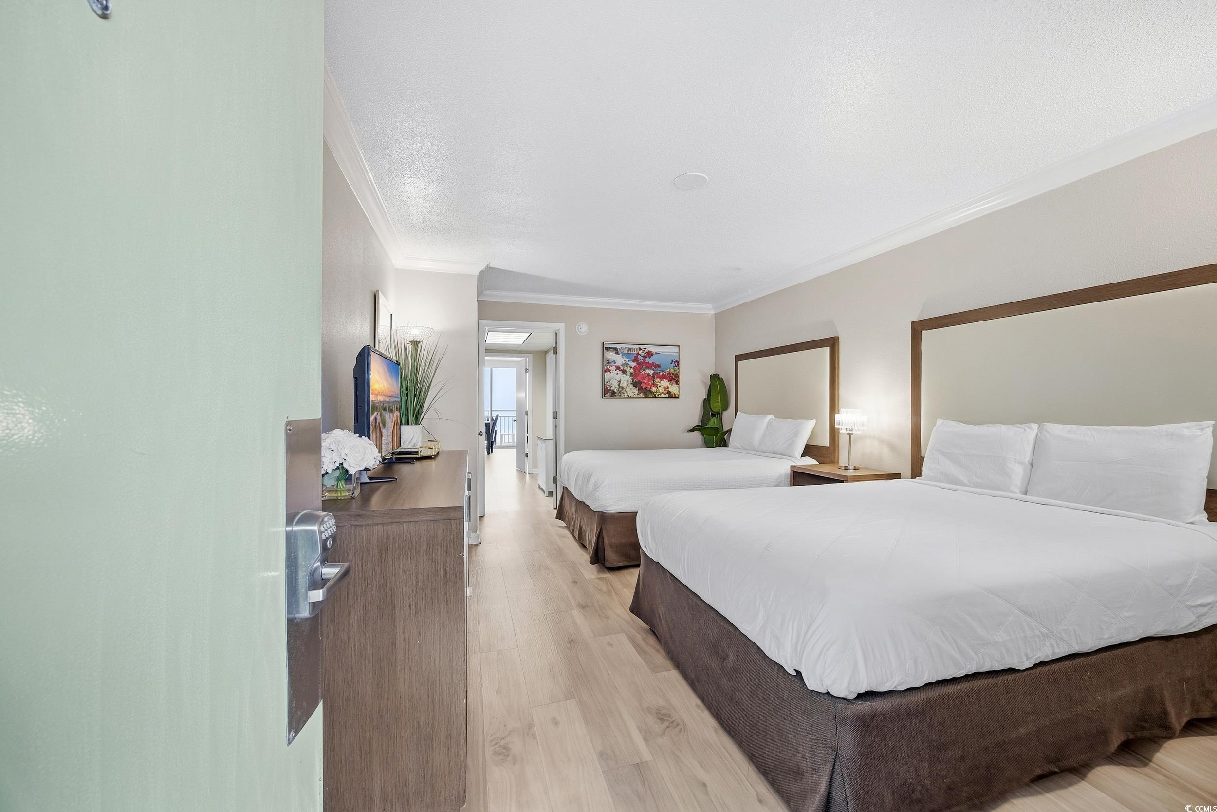 1105 South Ocean Boulevard, Unit 932 Myrtle Beach, SC 29577 - Photo 8 of 32 Bedroom with light wood-style flooring and ornamental molding