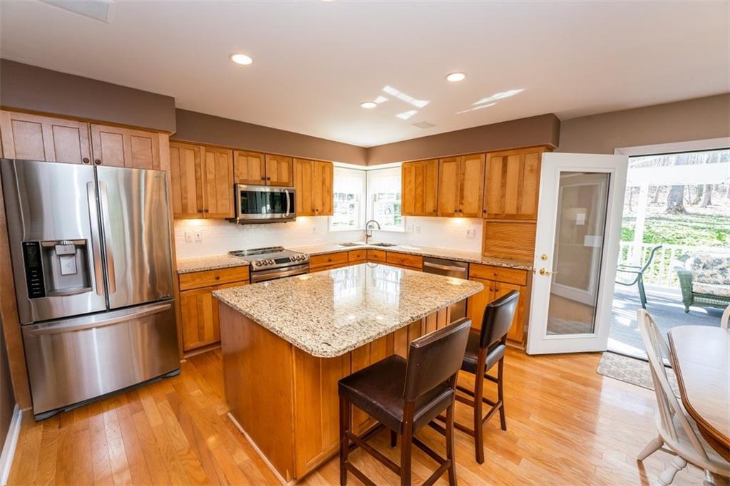 346 Forest Ridge Road Indiana, PA 15701 - Photo 11 of 25 a kitchen with stainless steel appliances granite countertop a refrigerator a stove a sink a dining table and chairs