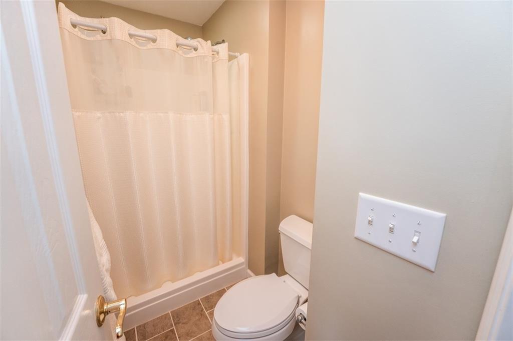 346 Forest Ridge Road Indiana, PA 15701 - Photo 21 of 25 a white toilet sitting next to a shower curtain