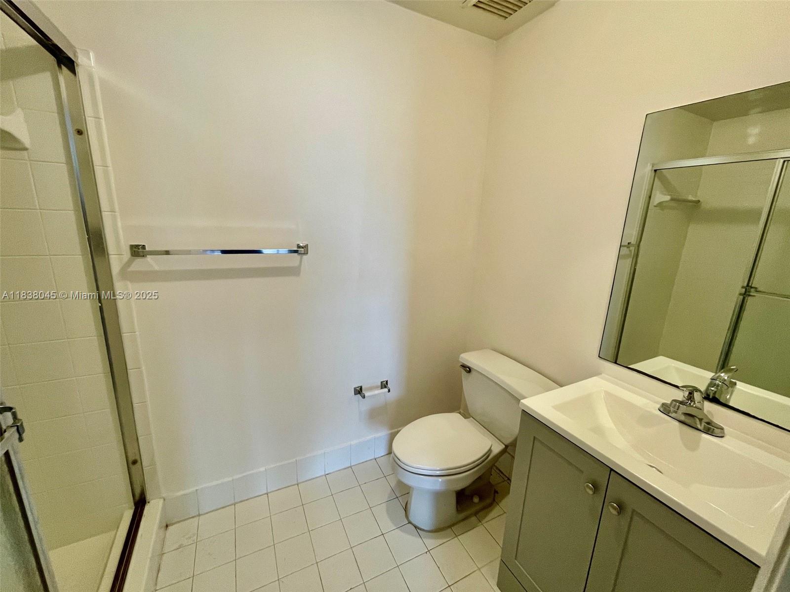 6984 Southwest 39th Street, Unit H202 Davie, FL 33314 - Photo 15 of 17 a bathroom with a toilet sink and shower