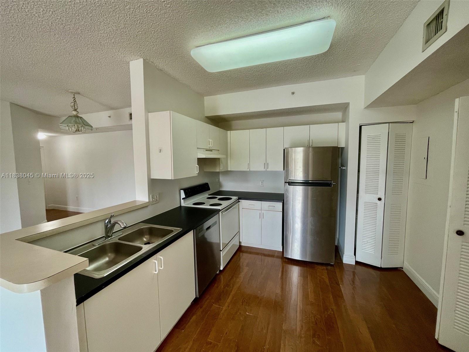 6984 Southwest 39th Street, Unit H202 Davie, FL 33314 - Photo 4 of 17 a kitchen with a stove and a refrigerator