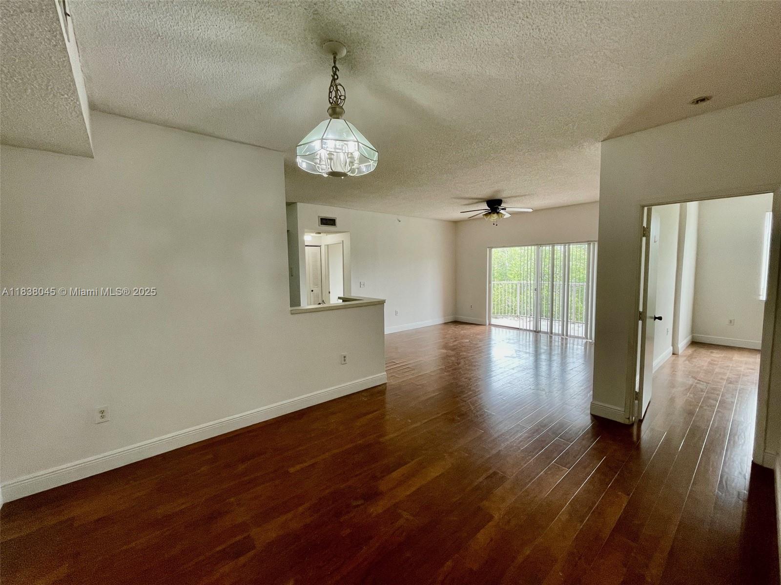 6984 Southwest 39th Street, Unit H202 Davie, FL 33314 - Photo 6 of 17 a view of a room with wooden floor and window