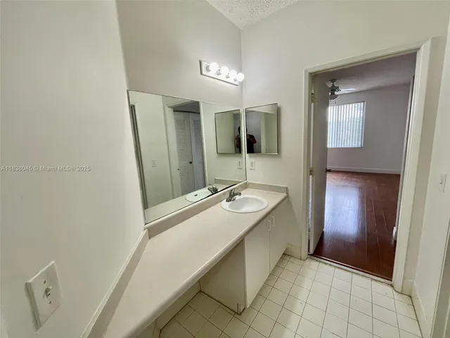 a bathroom with a tub sink and mirror