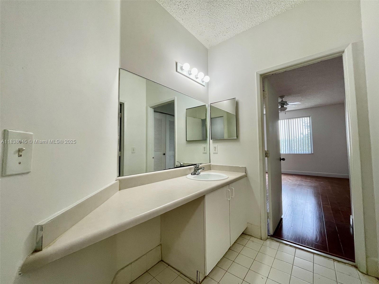 6984 Southwest 39th Street, Unit H202 Davie, FL 33314 - Photo 10 of 17 a spacious bathroom with a granite countertop sink mirror and bathtub