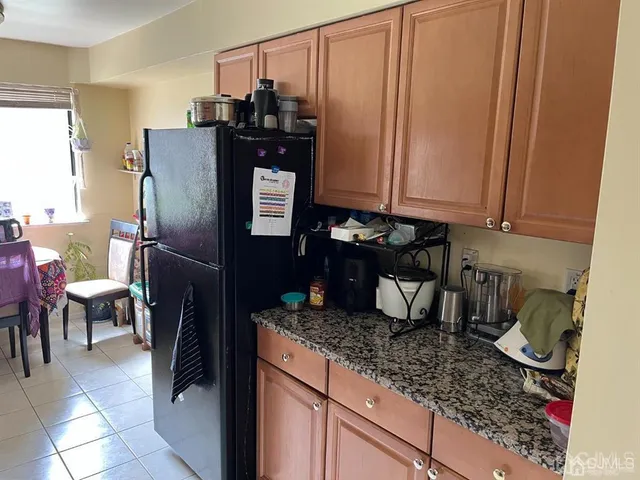 a kitchen with refrigerator and cabinets