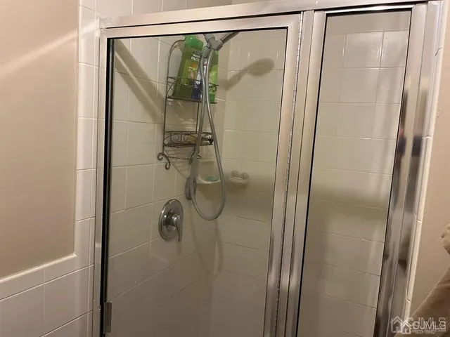 a bathroom with a glass shower door
