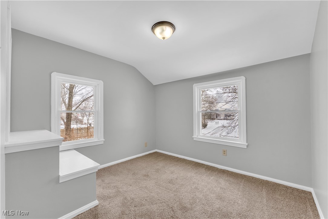 4693 Liberty Road South Euclid, OH 44121 - Photo 19 of 33 Spare room with vaulted ceiling, light colored carpet, and healthy amount of natural light