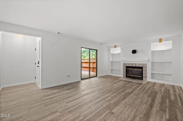 wooden floor fireplace and natural light in room